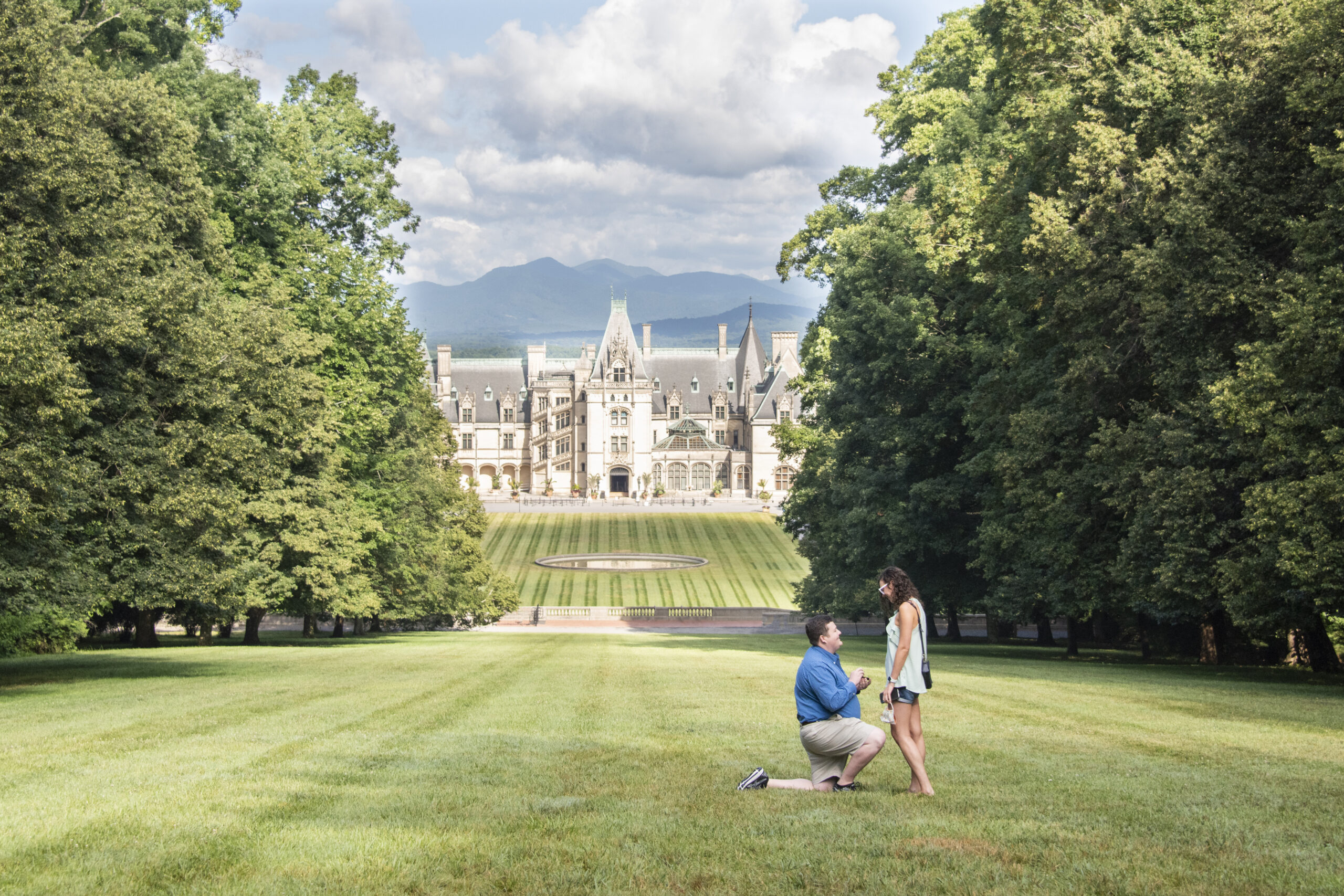 Man proposing to woman at Biltmore Estate in Asheville, NC with mountain views