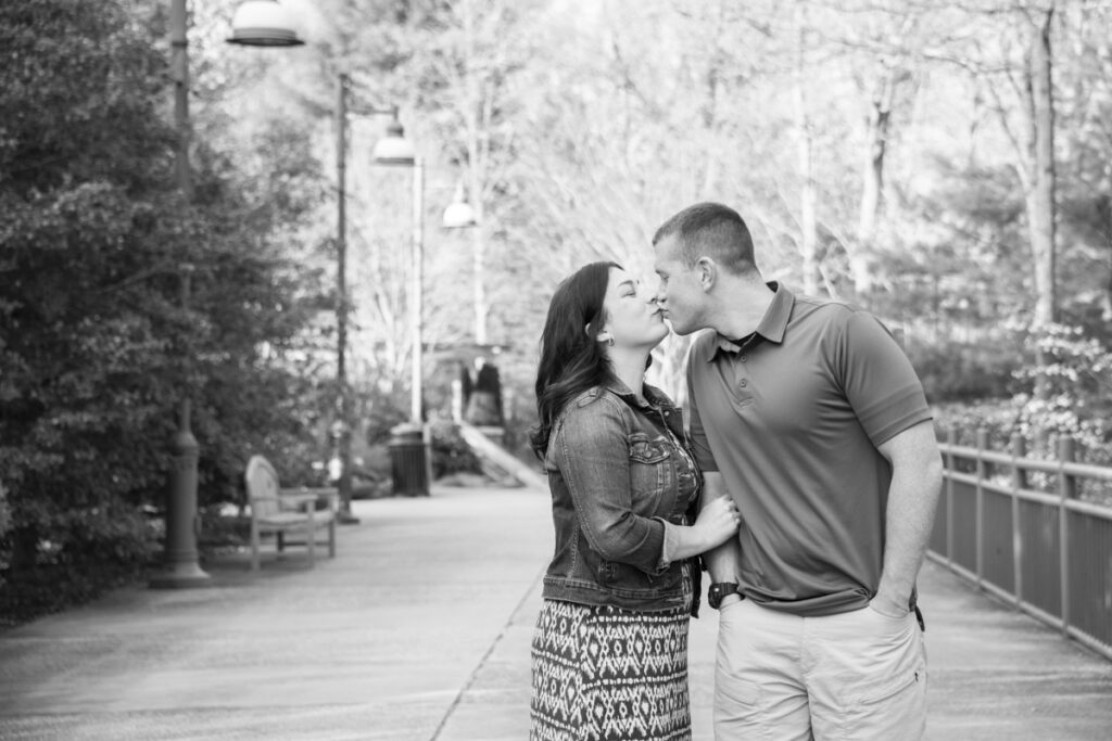 couple kissing at photo shoot at The NC Arboretum in black and white in Adsheville, NC