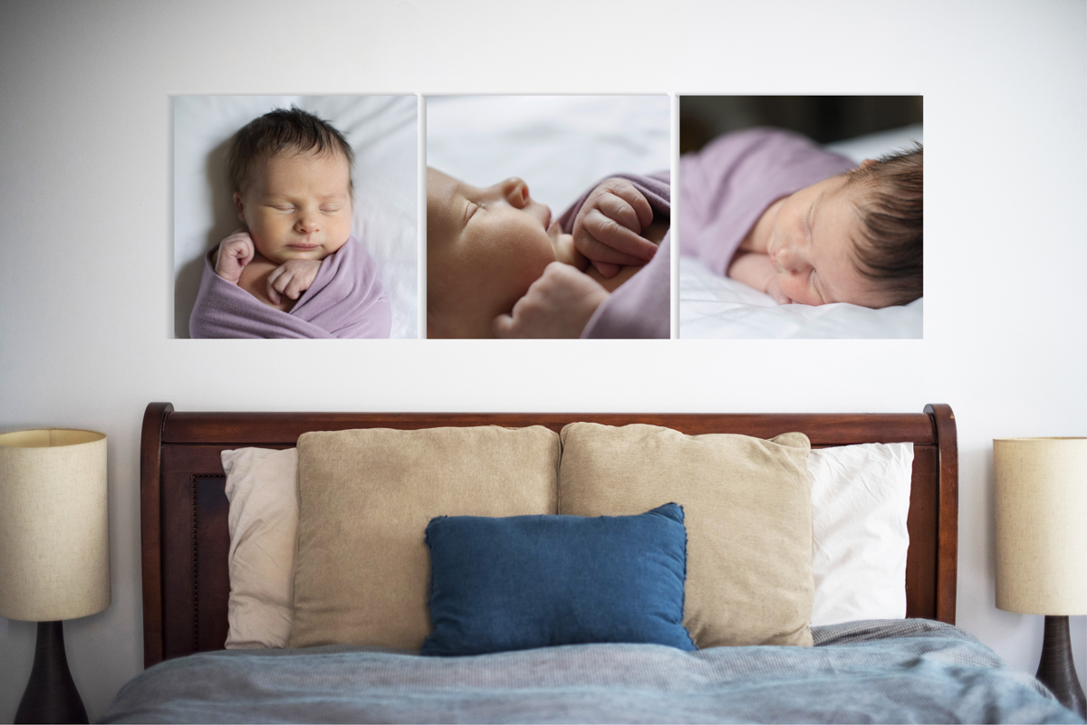 three canvases of a newborn baby above bed.