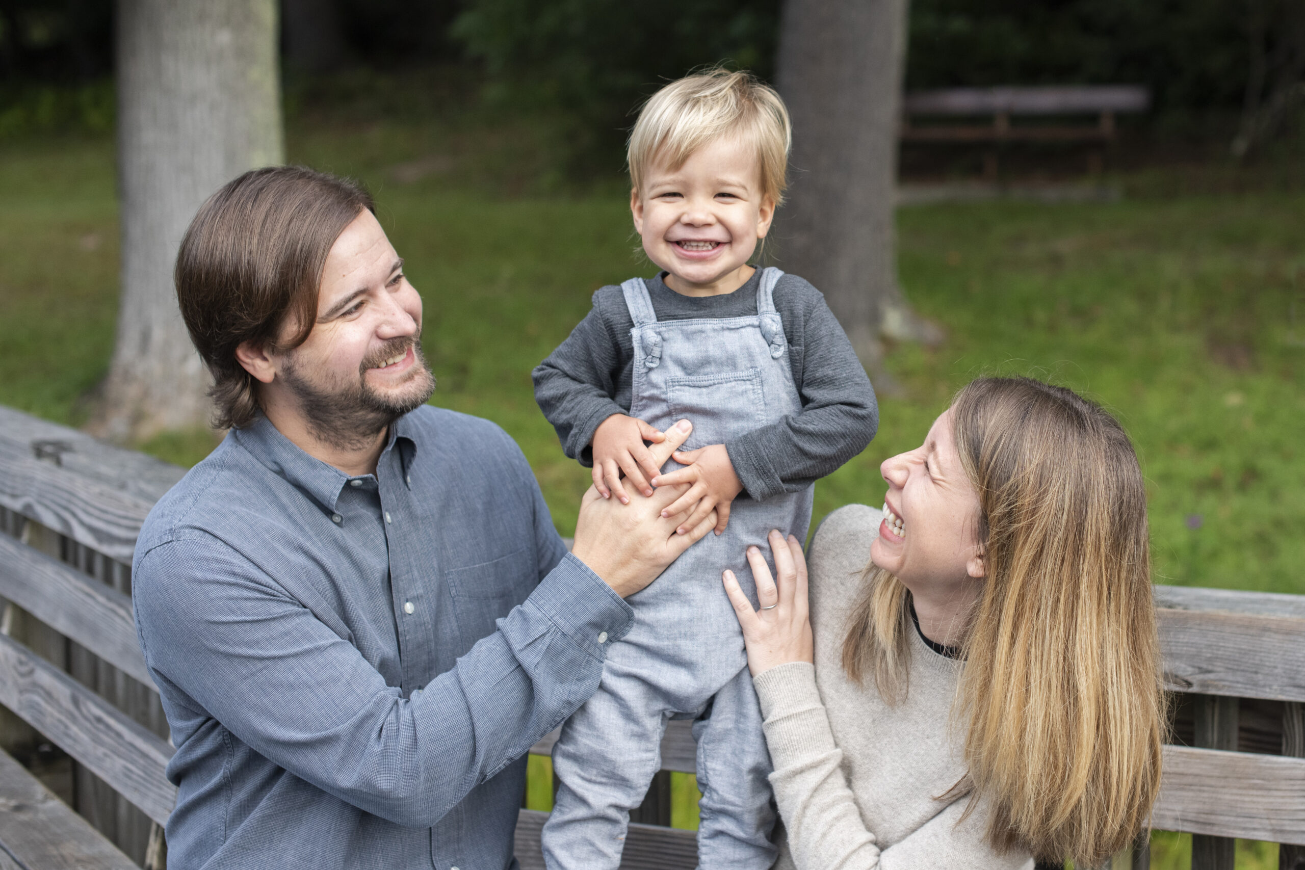 little boy laughing with parents during family photos