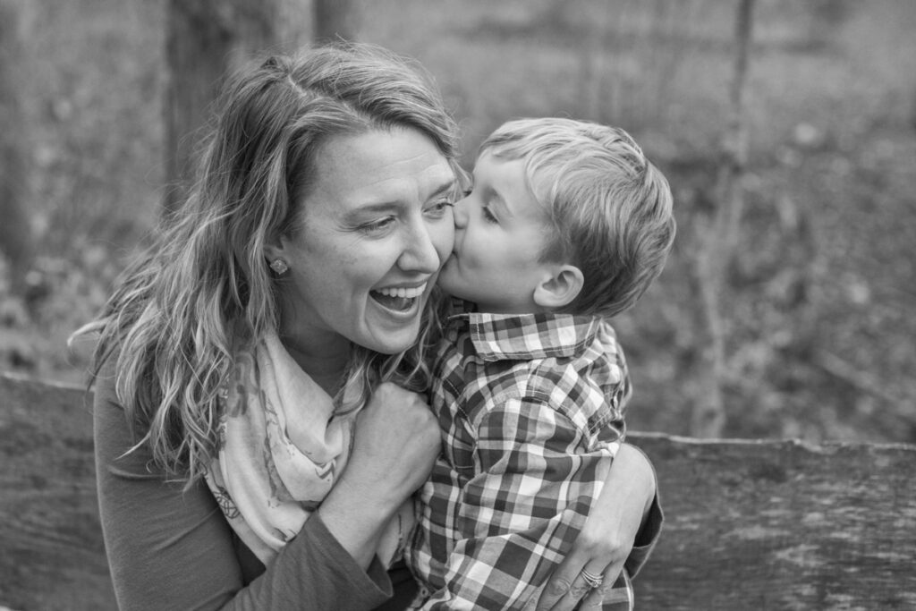 little boy kissing Mom on the cheek during photos in Asheville, NC