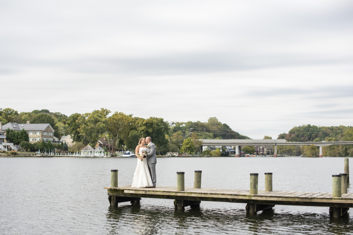 Wedding couple standing on dock at The River View at Occoquan on wedding day in Lorton, VA