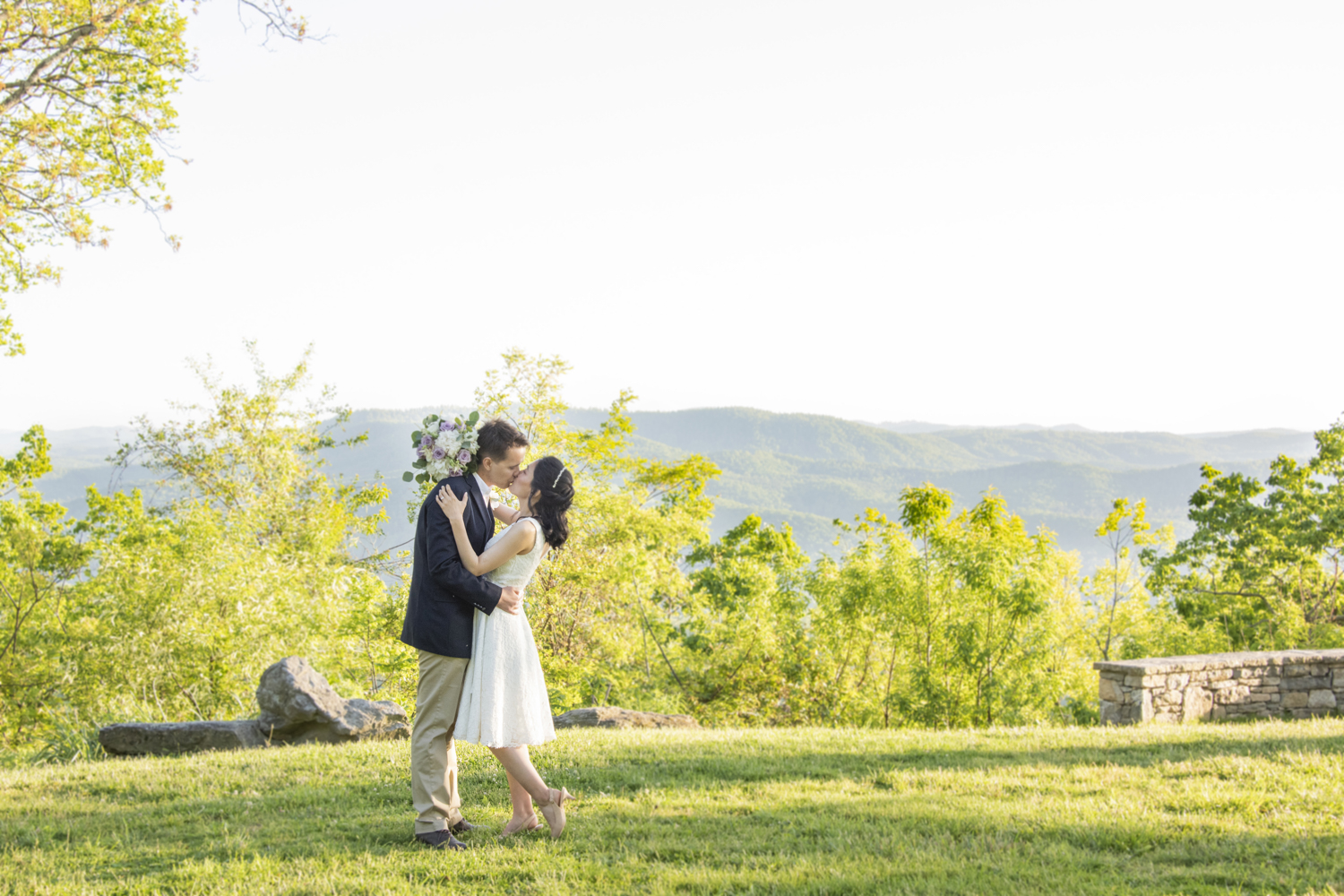 Couple kissing at wedding with mountain views