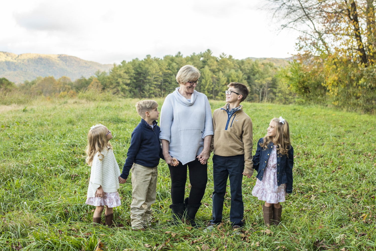 Grandma and grandkids in a field with mountain views