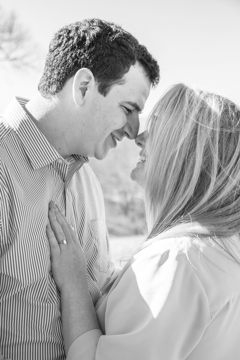 Couple touching noses at Biltmore Estate in Asheville after engagement