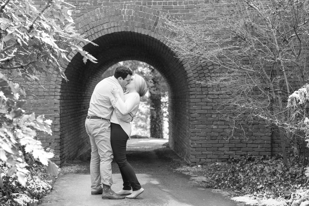 Couple kissing at Biltmore Estate after engagement