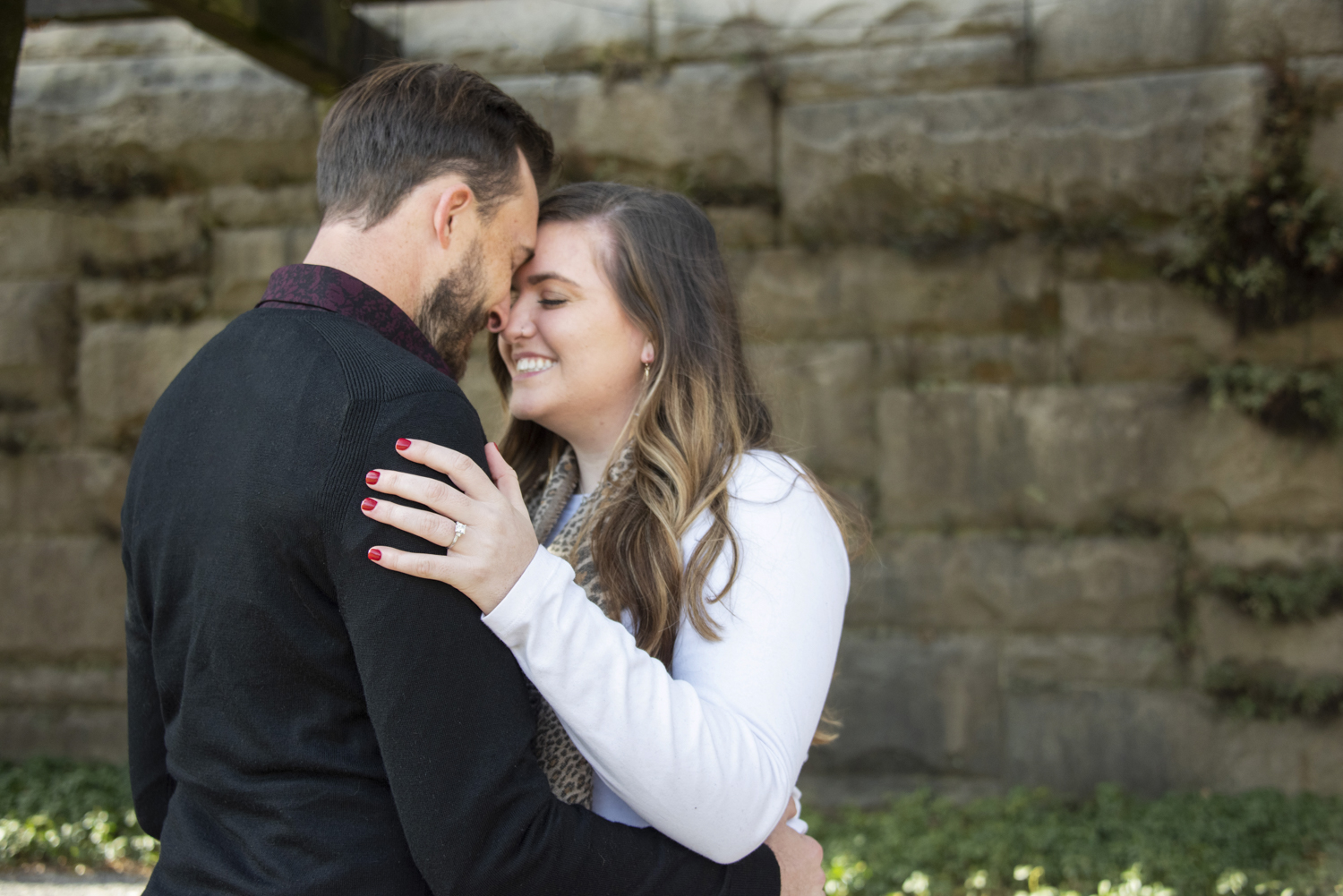 Man and woman touching foreheads after proposal at Biltmore Estate in Asheville, NC