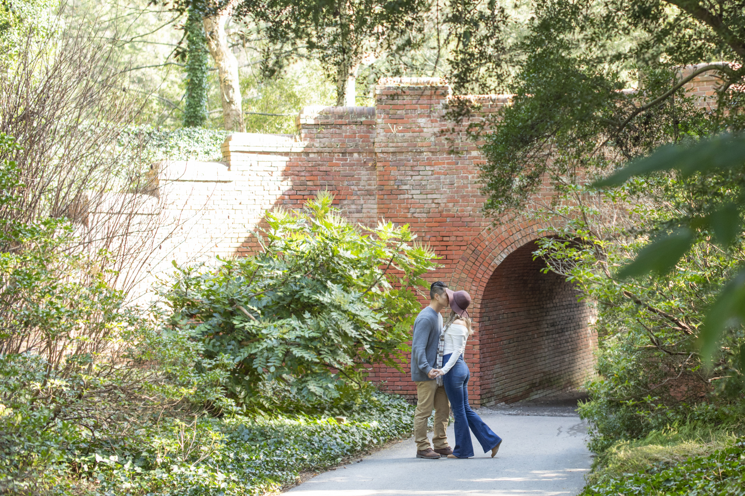 Couple kissing after proposal at Biltmore Estate in Asheville, NC