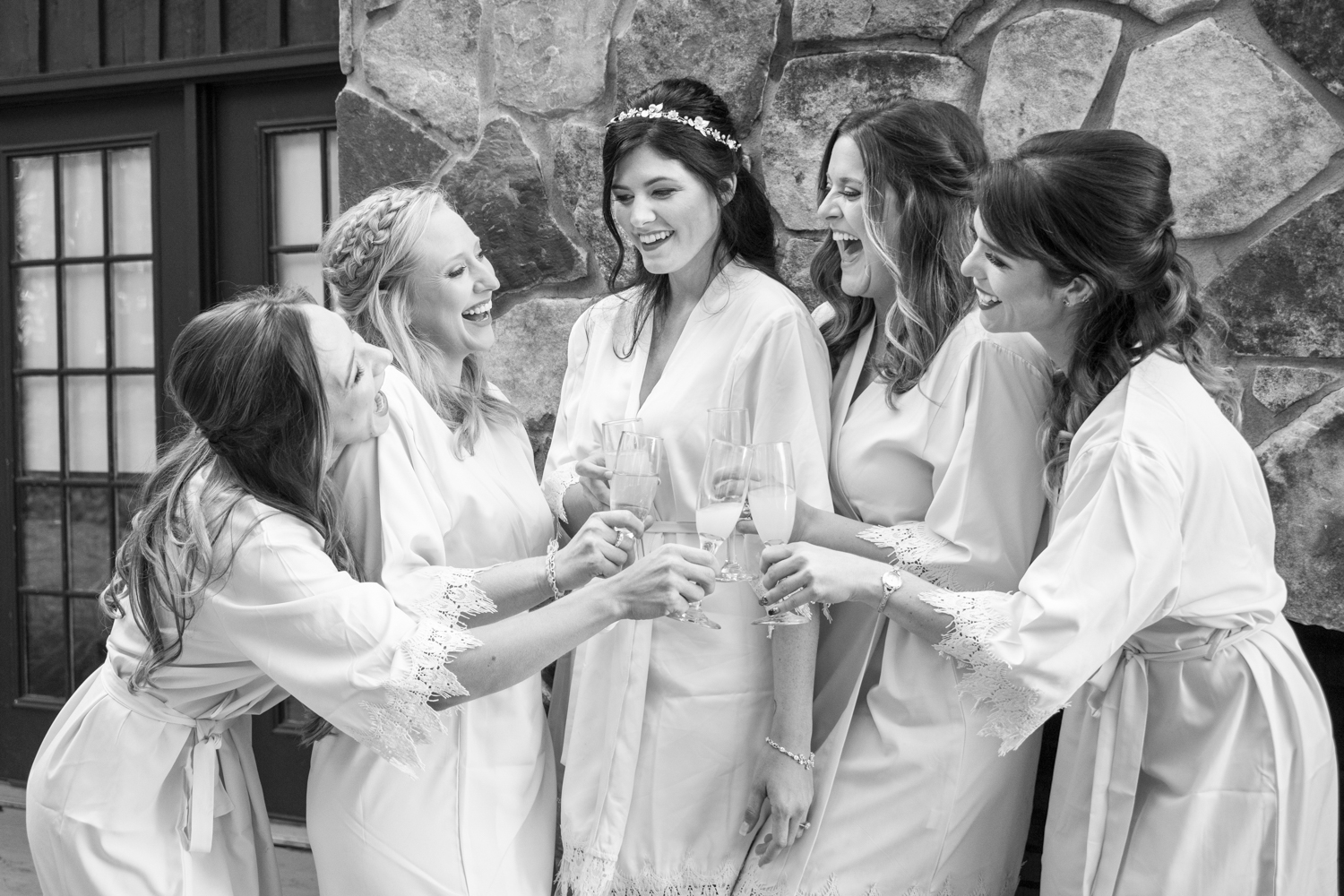 Bride cheers with bridesmaids