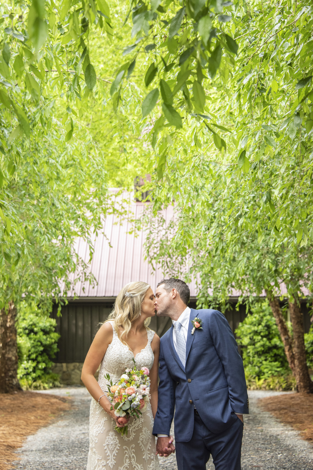 Couple kissing under trees