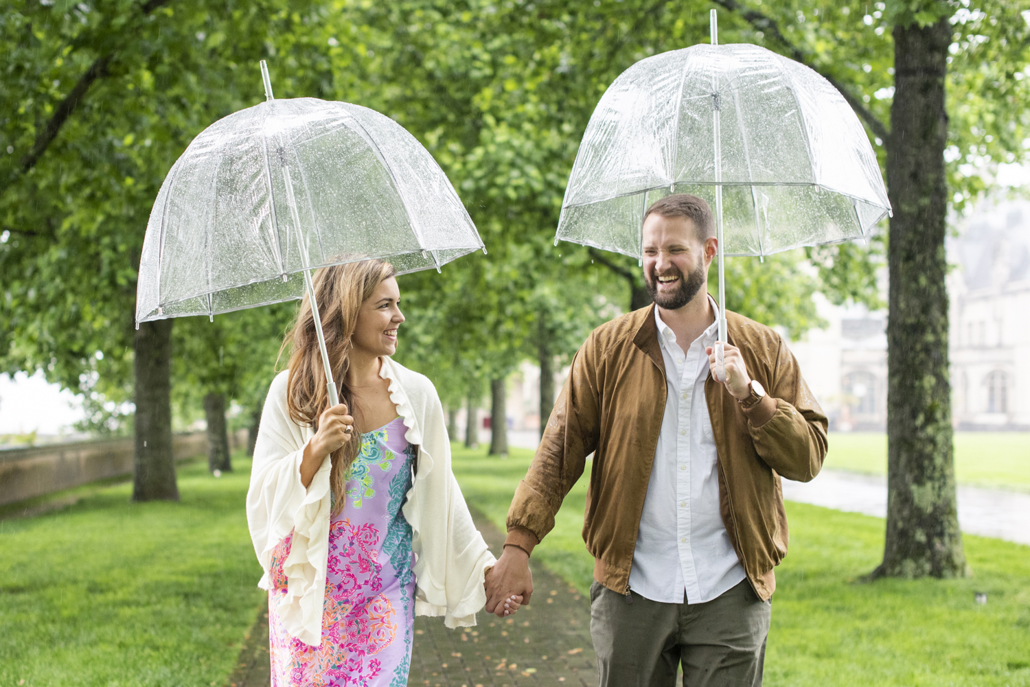 Couple walking in rain at Biltmore Estate with umbrellas