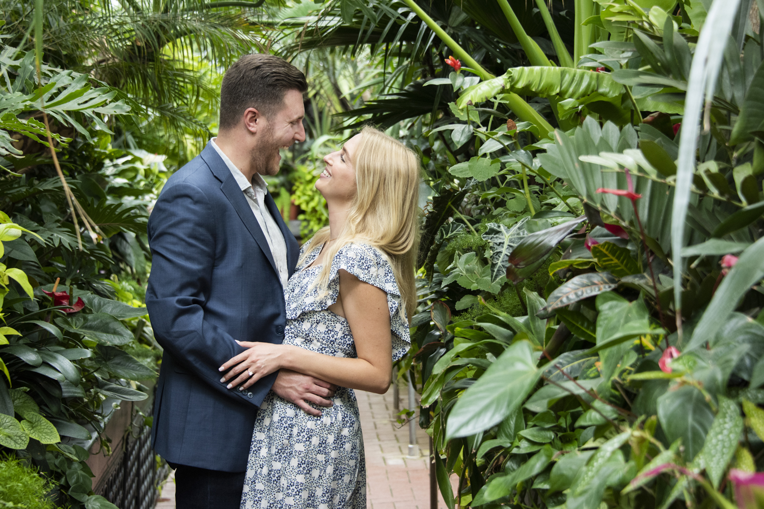 Couple laughing in conservatory at Biltmore Estate after engagement.