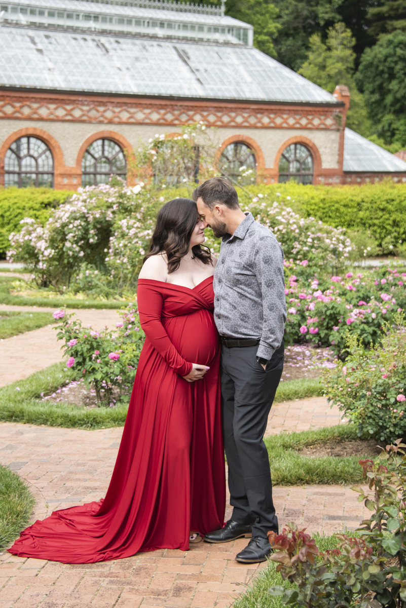 Couple snuggling in Biltmore's garden during Asheville Maternity Photography