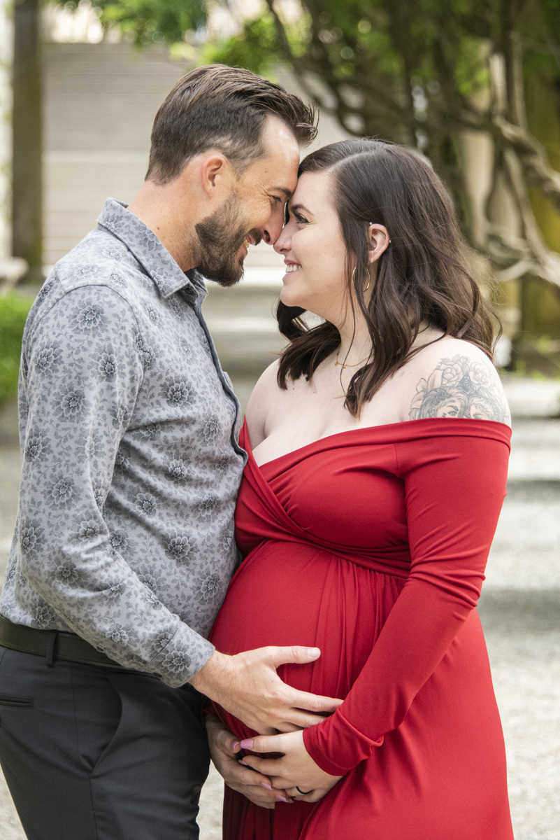 Couple snuggling and smiling during maternity photos