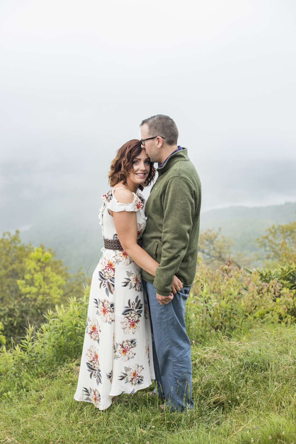 Couple standing among fog at Engagement Photo Locations in Asheville