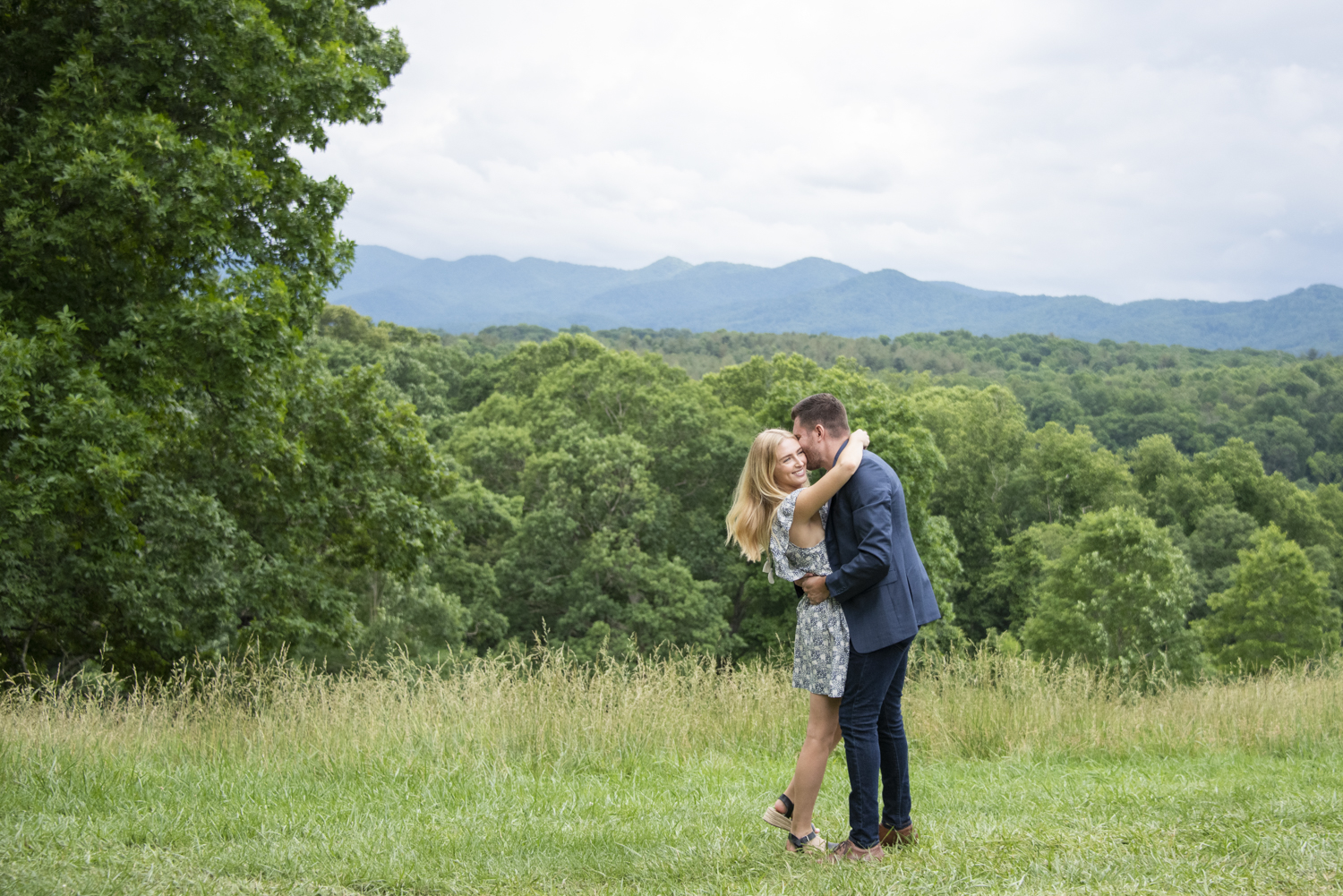 Couple hugging with mountain view in Asheville, NC.