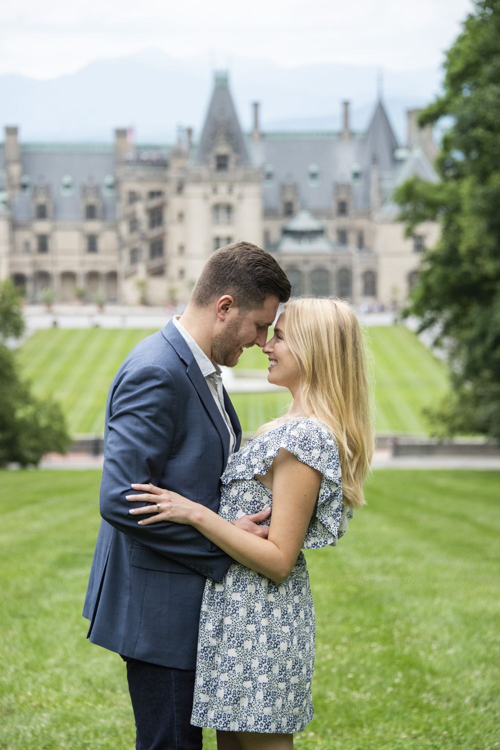 Biltmore Estate Proposal Photography of couple touching noses with mountain view