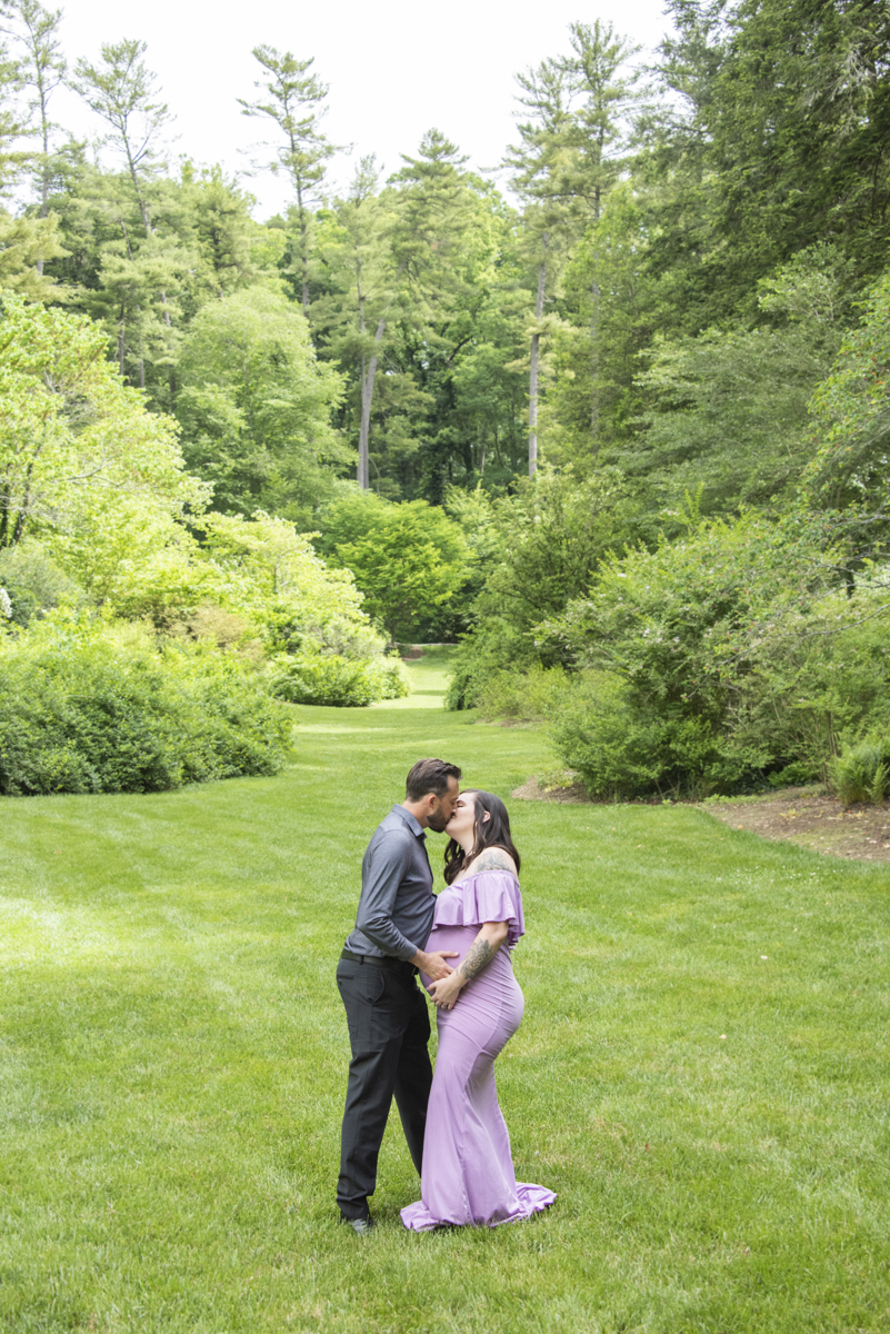 Couple kissing on lawn at Asheville Maternity Photography