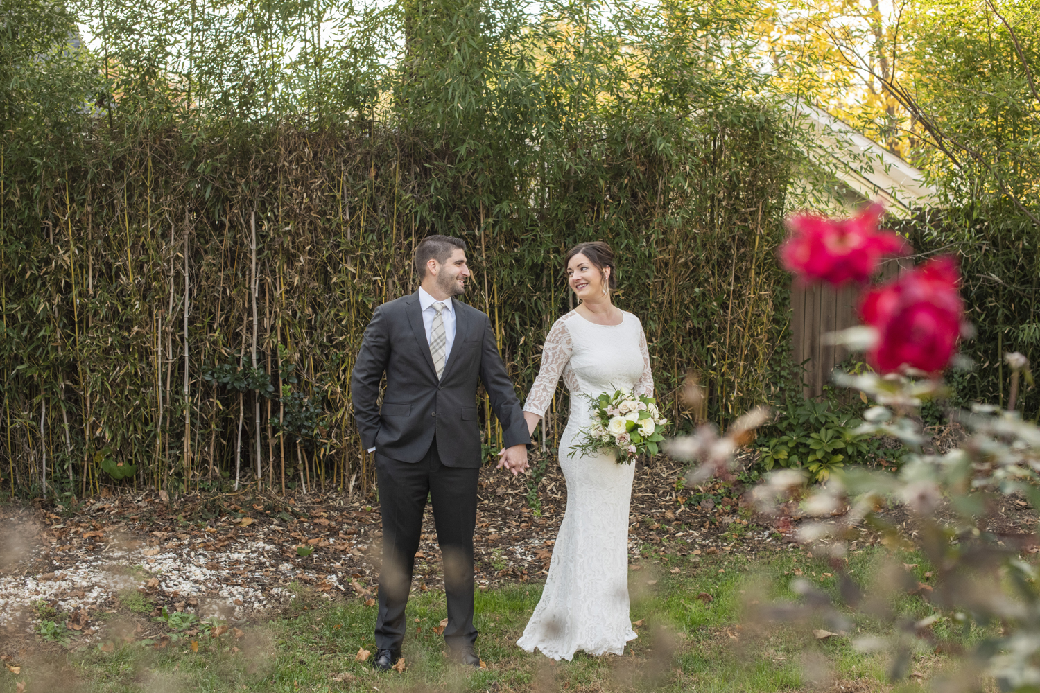 Couple holding hands in the rose garden