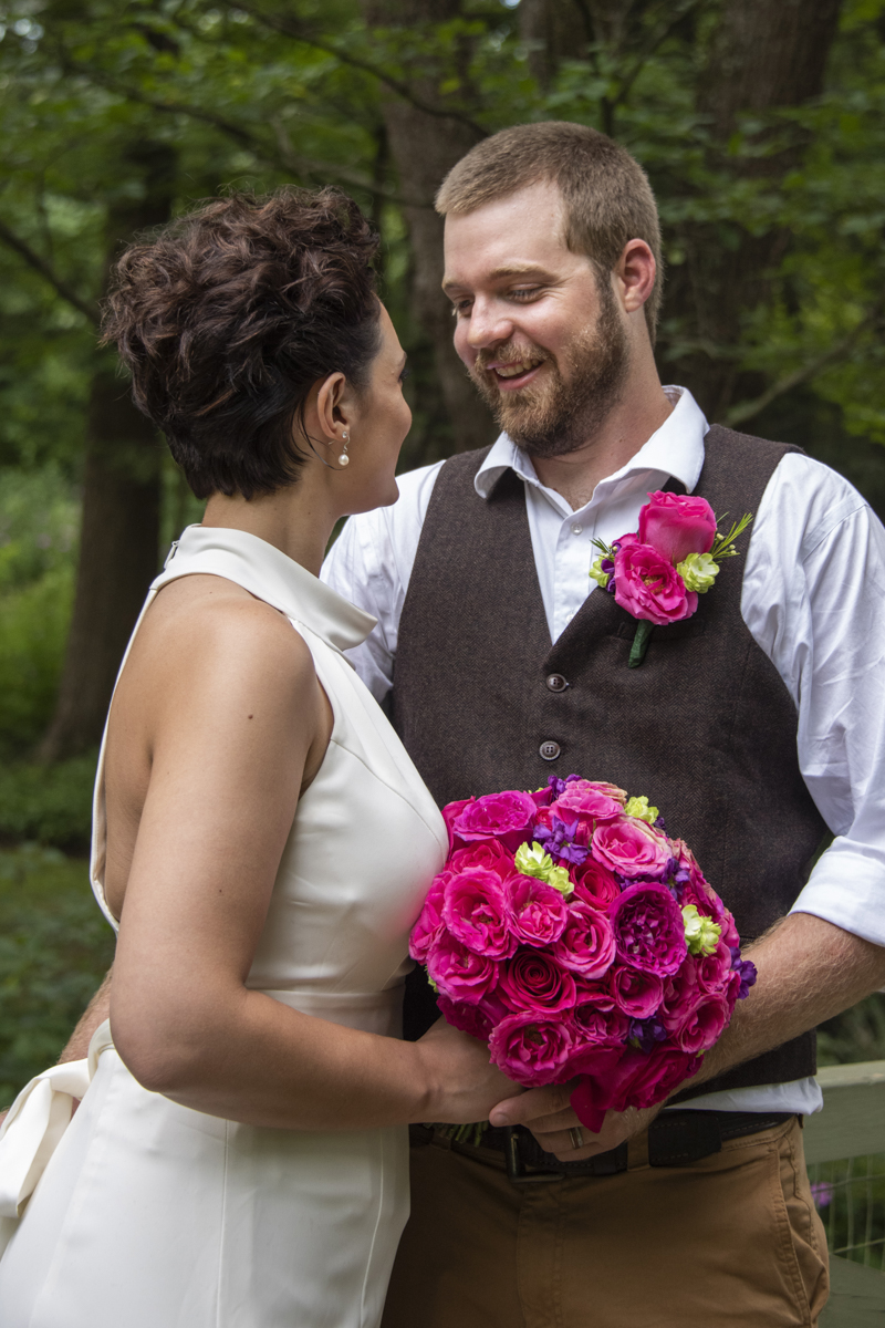 Groom laughing with bride at Asheville Botanical Gardens elopement