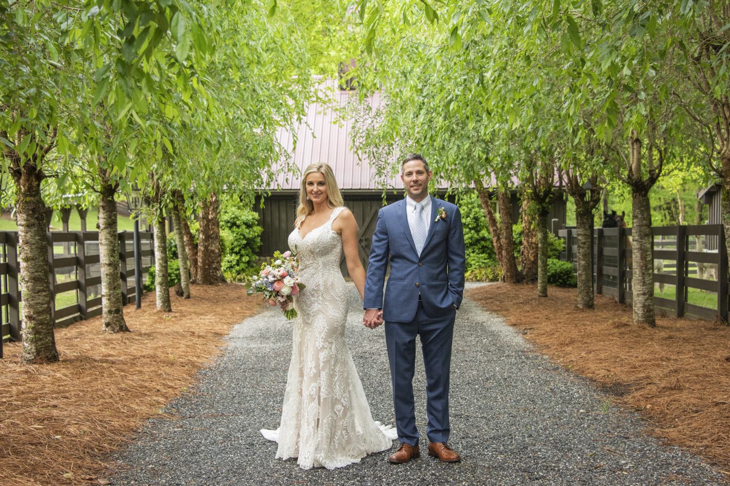 Couple holding hands looking at camera