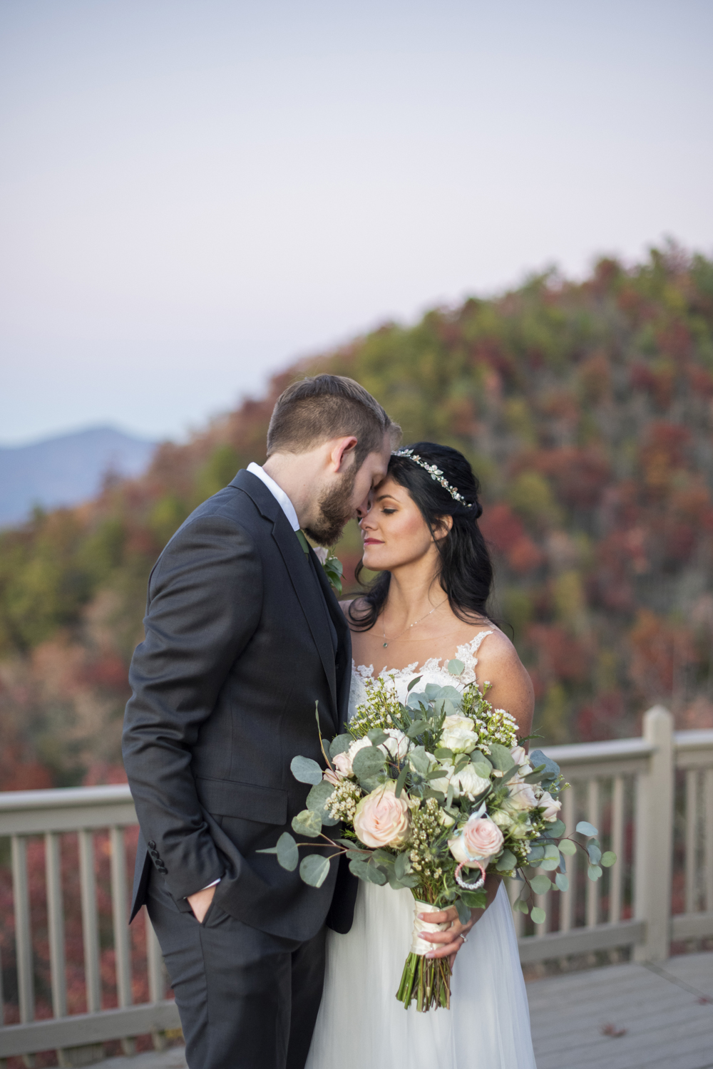 Couple snuggling on mountain top at Hawkesdene Fall Wedding Photography