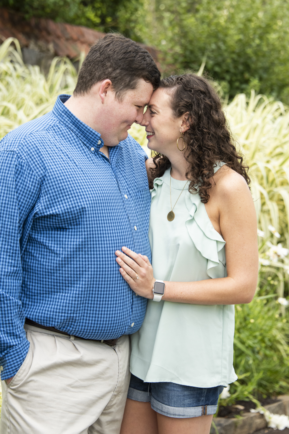 Couple snugging in Biltmore garden