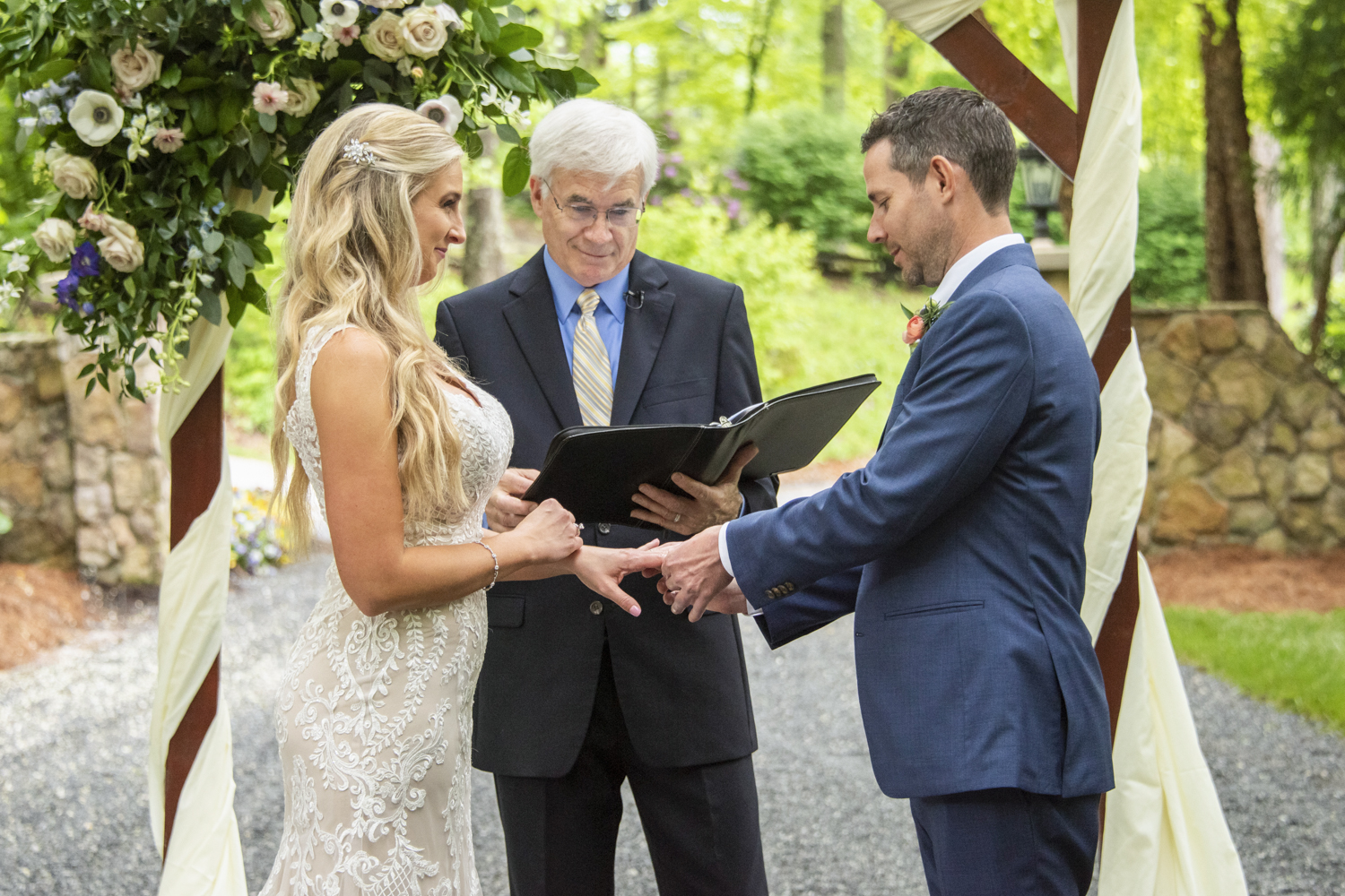 Couple exchanging rings during wedding ceremony