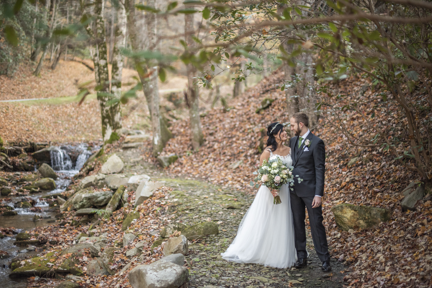 Couple next to creek at Hawkesdene Fall Wedding Photography