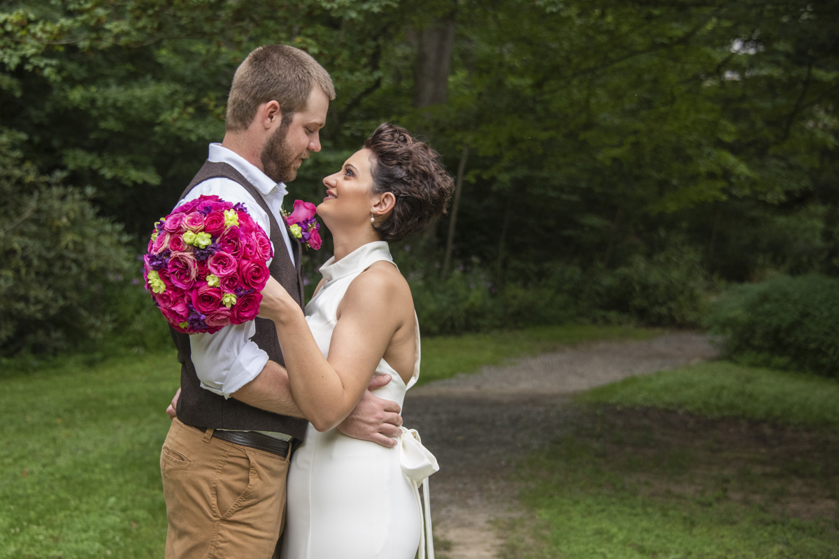 Couple snuggling at Asheville Botanical Gardens elopement