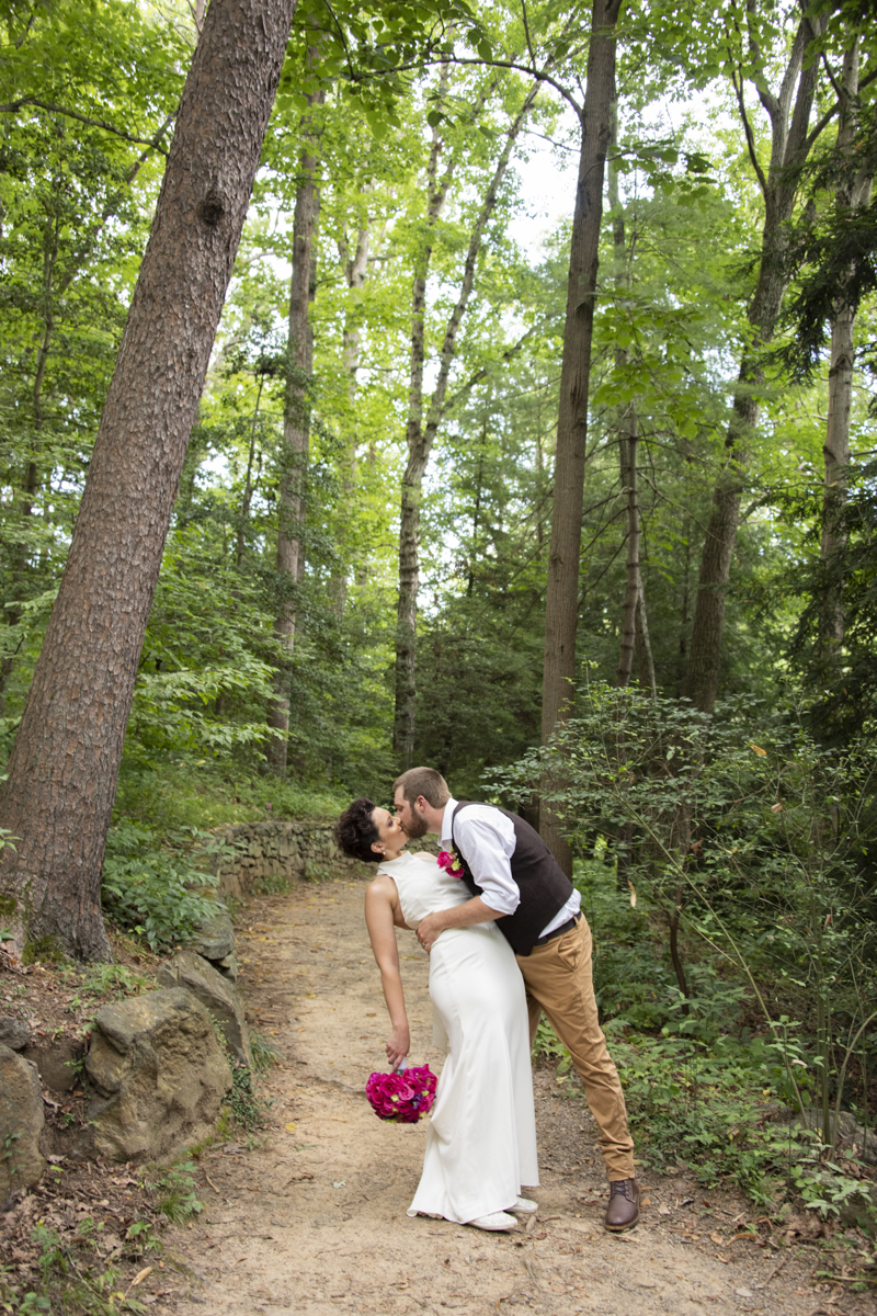 Couple dipping on trail at Asheville Botanical Gardens elopement