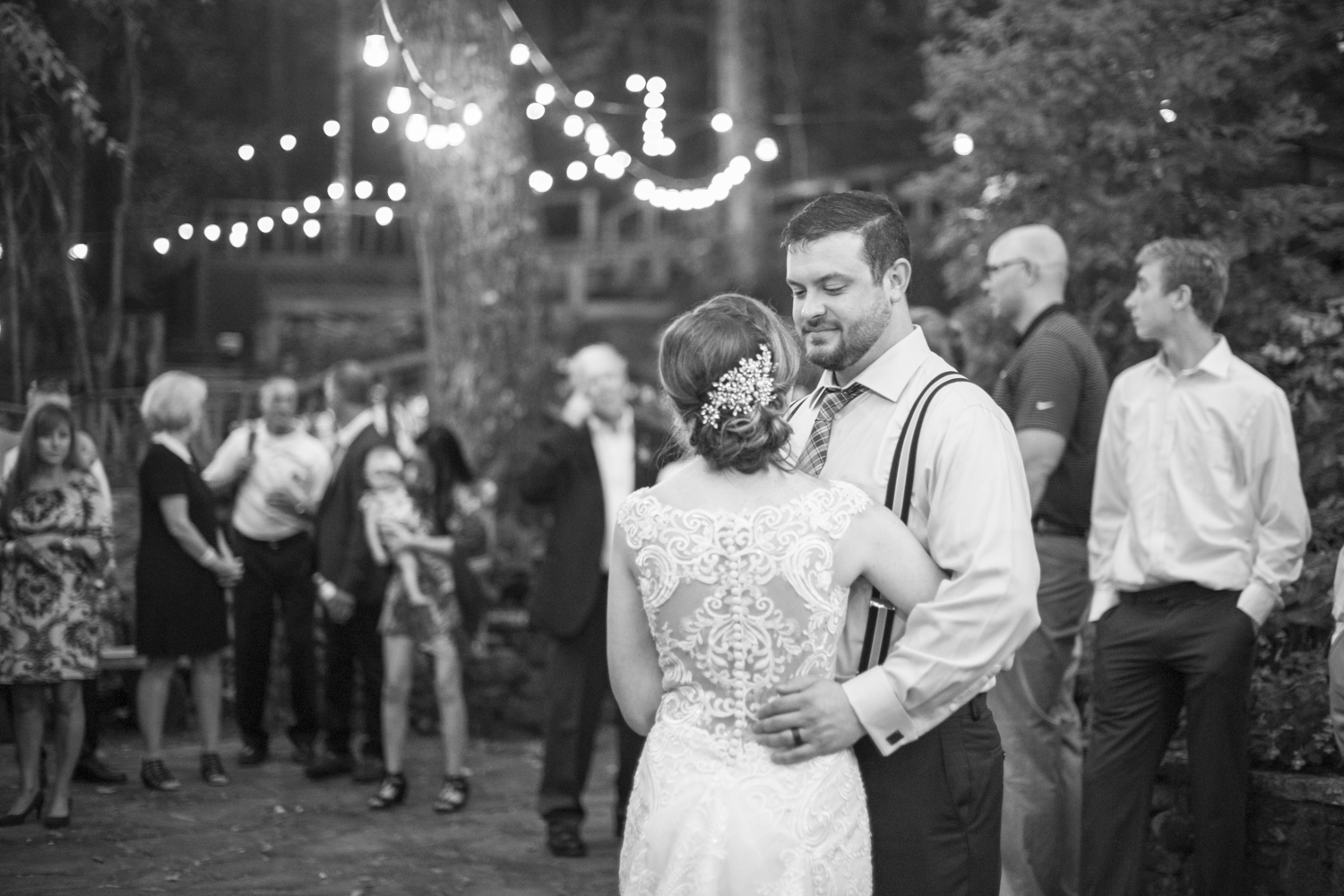 Couple dancing under string lights at Willow Falls Wedding Photography