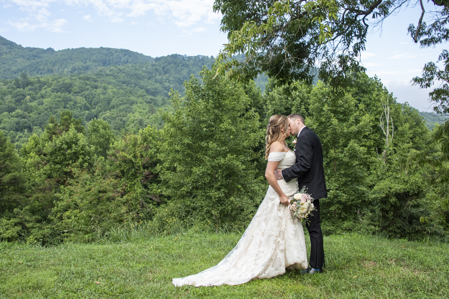 Couple kissing with mountain views at Engadine Inn Wedding Photography