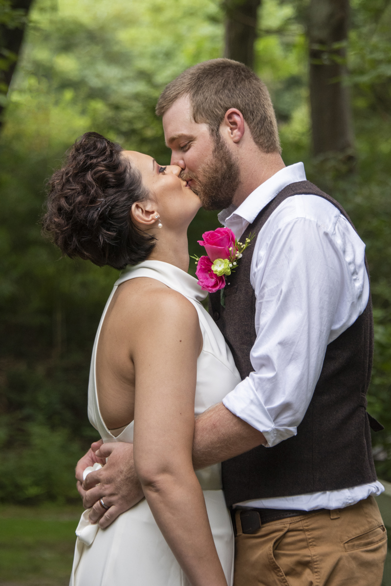 Couple kissing during photos at Asheville Botanical Gardens elopement