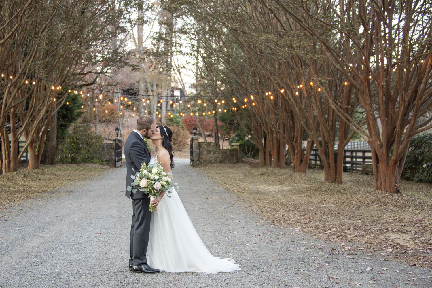 Couple kissing under string lights