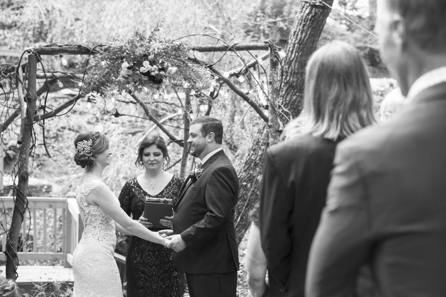 Couple holding hands during ceremony at Willow Falls Wedding Photography