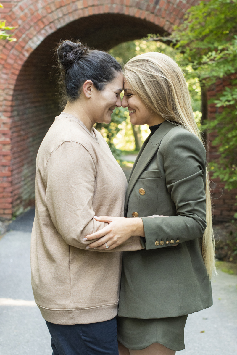 Couple snuggling after Asheville LGBTQ engagement photographer