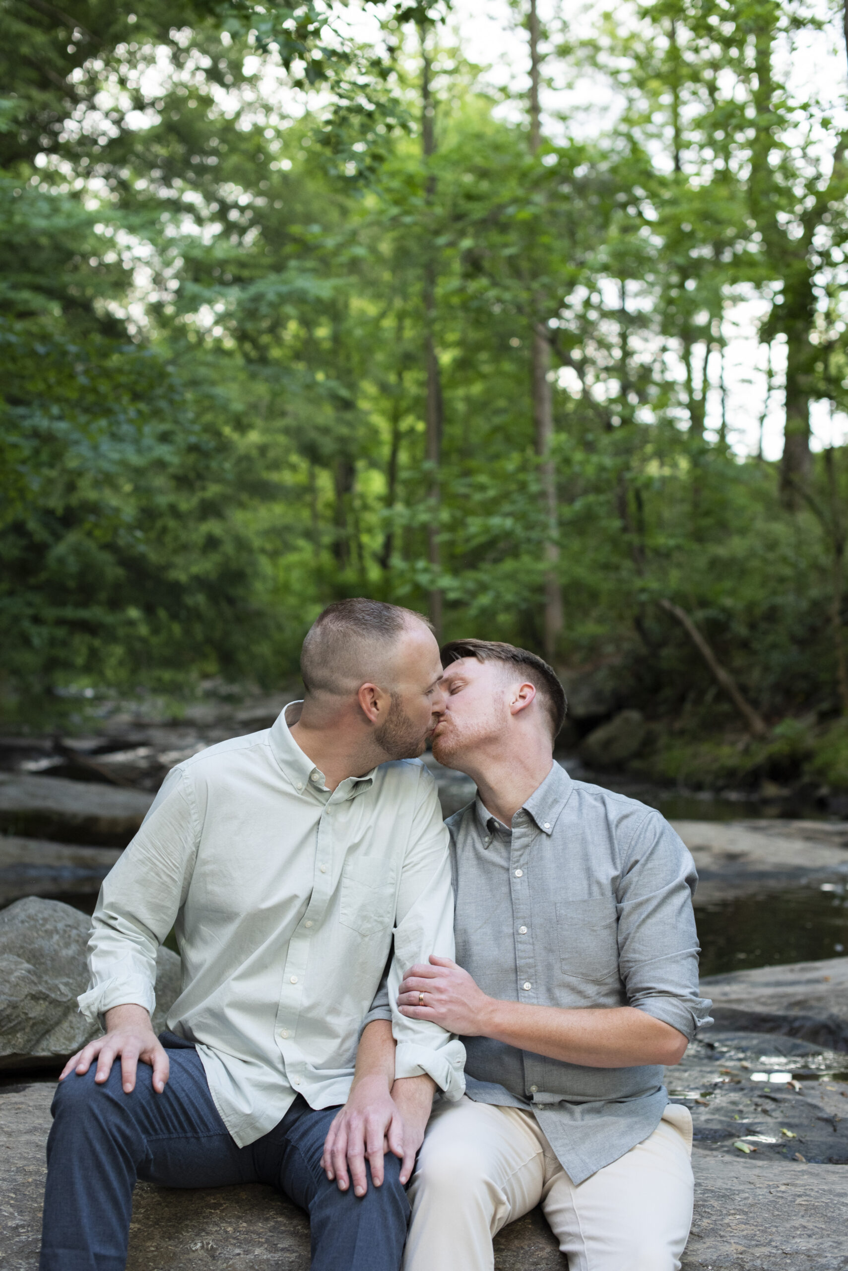 Couple kissing in creek at Asheville Engagement Photography at the Botanical Gardens