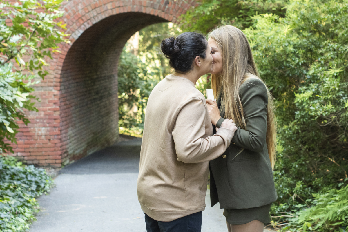 Couple kissing after proposal with Asheville LGBTQ engagement photographer