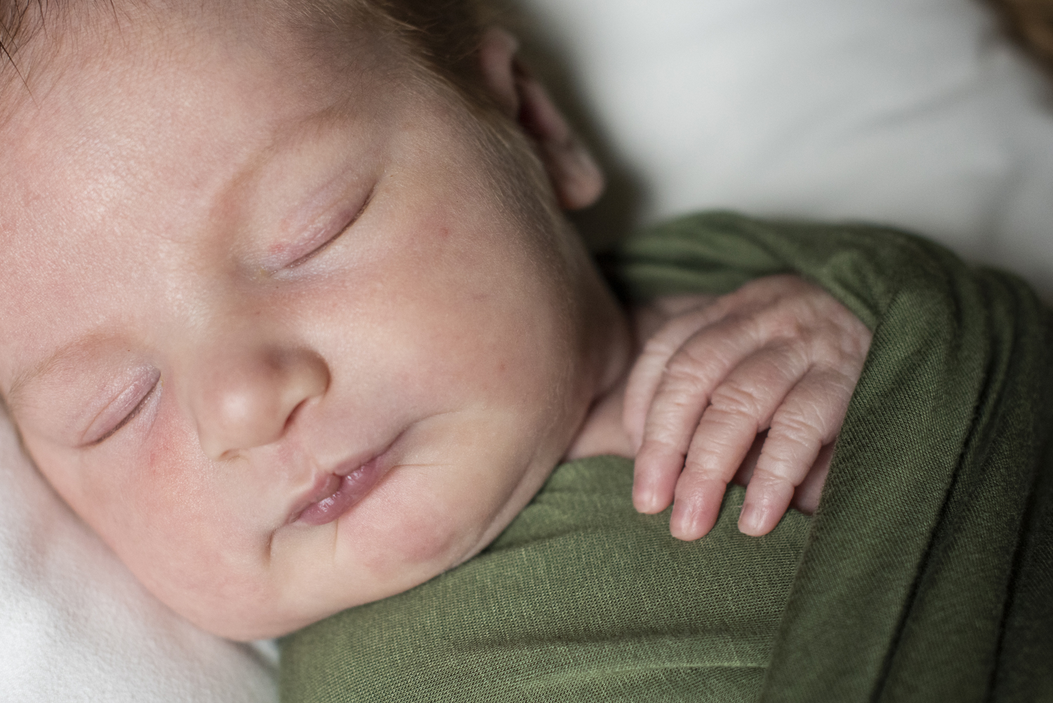 Close up of face and hand at home Newborn Photography in Asheville