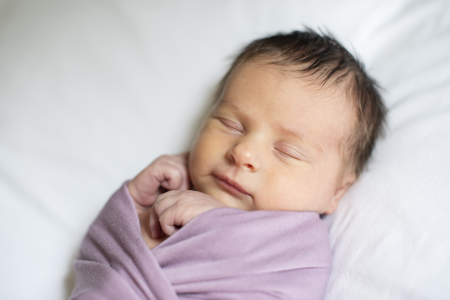 Asheville Newborn Photography of baby girl in purple swaddle