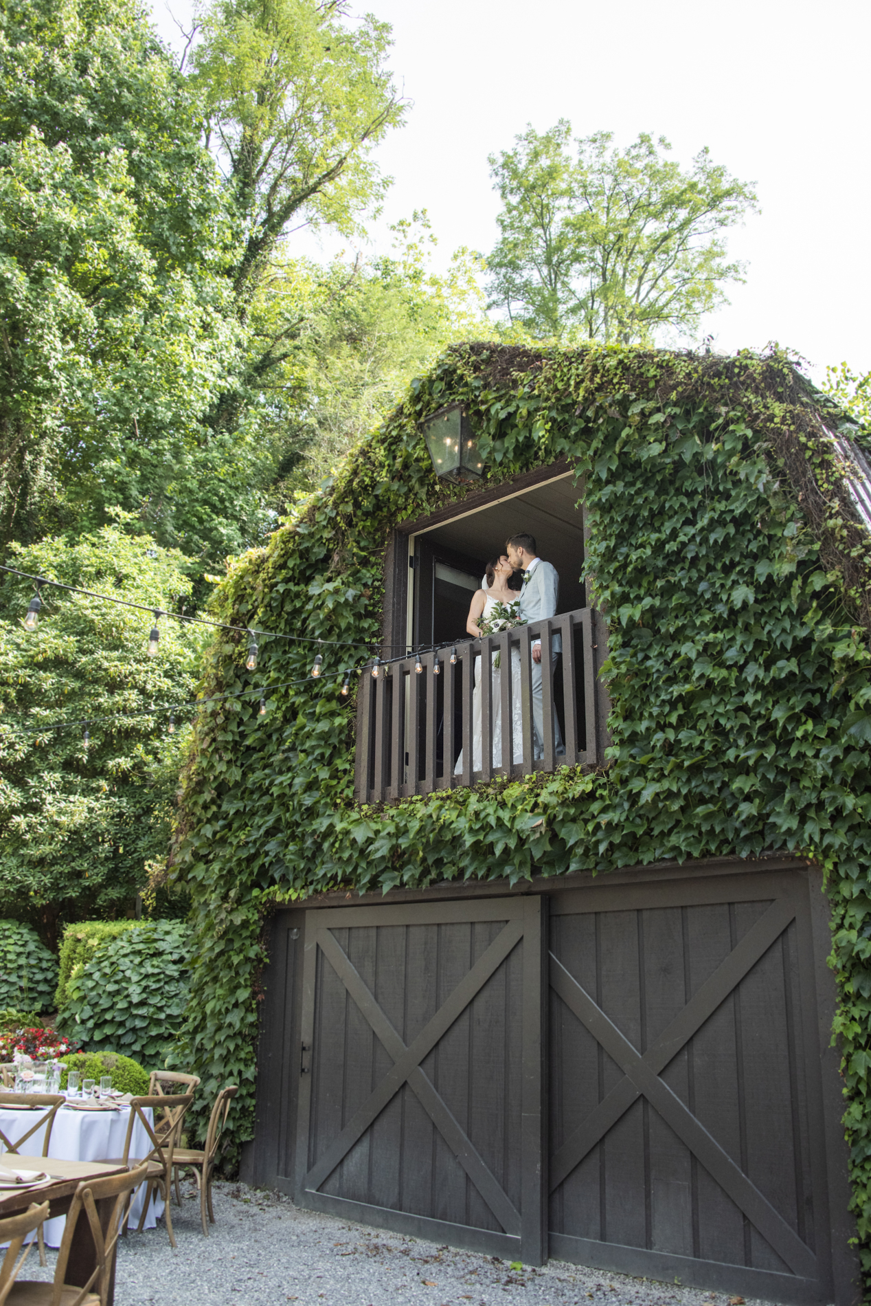 Couple kissing in loft with Hawkesdene Wedding Photographer