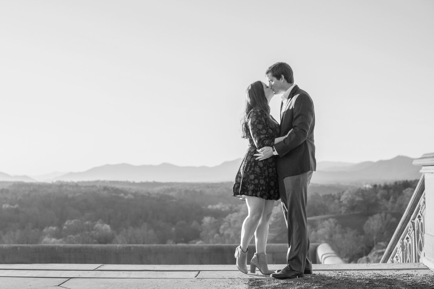 Couple kissing with mountain view at Biltmore Estate fall engagement photography