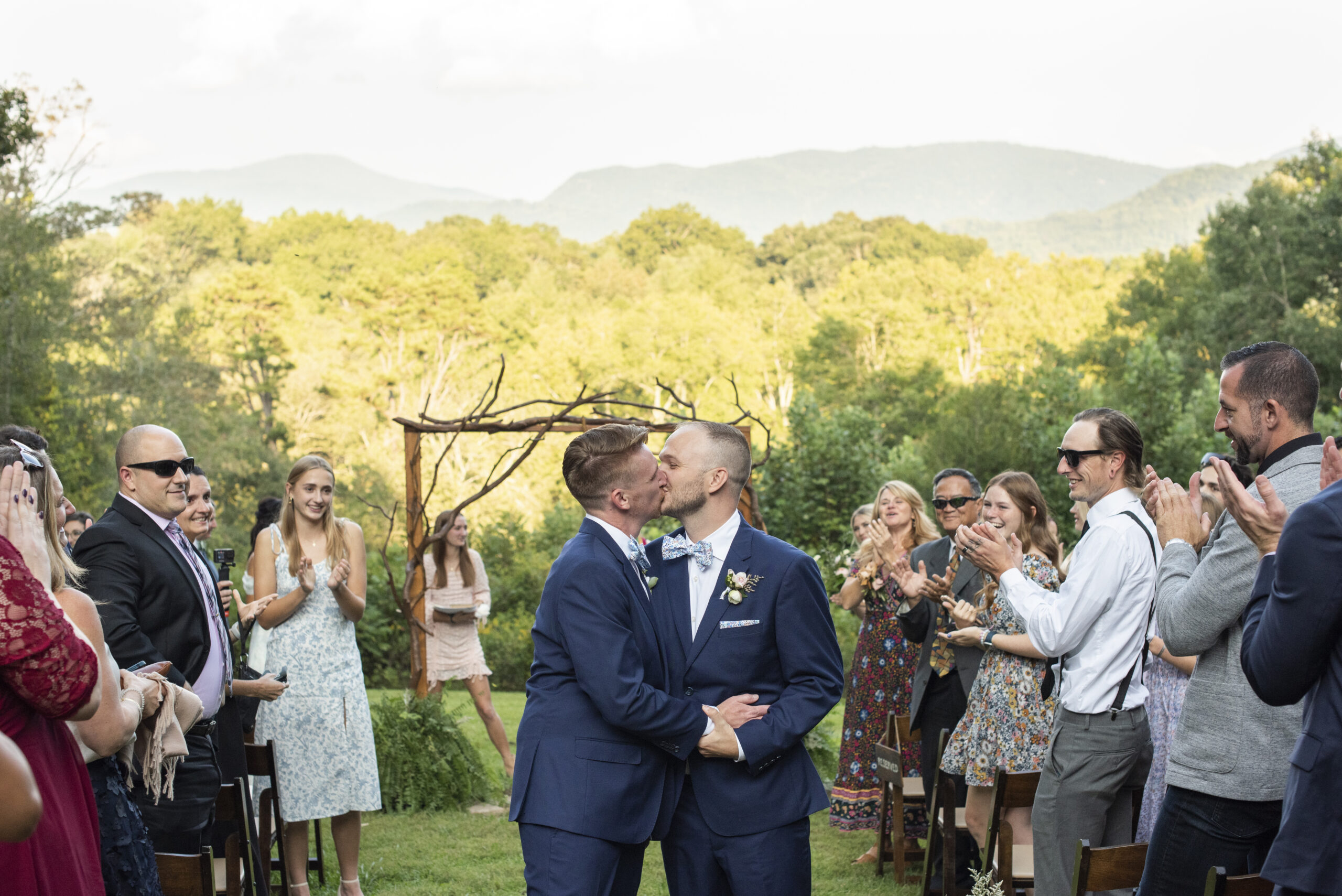 Gay couple kissing in wedding aisle at Twisty Maple Wedding Photography