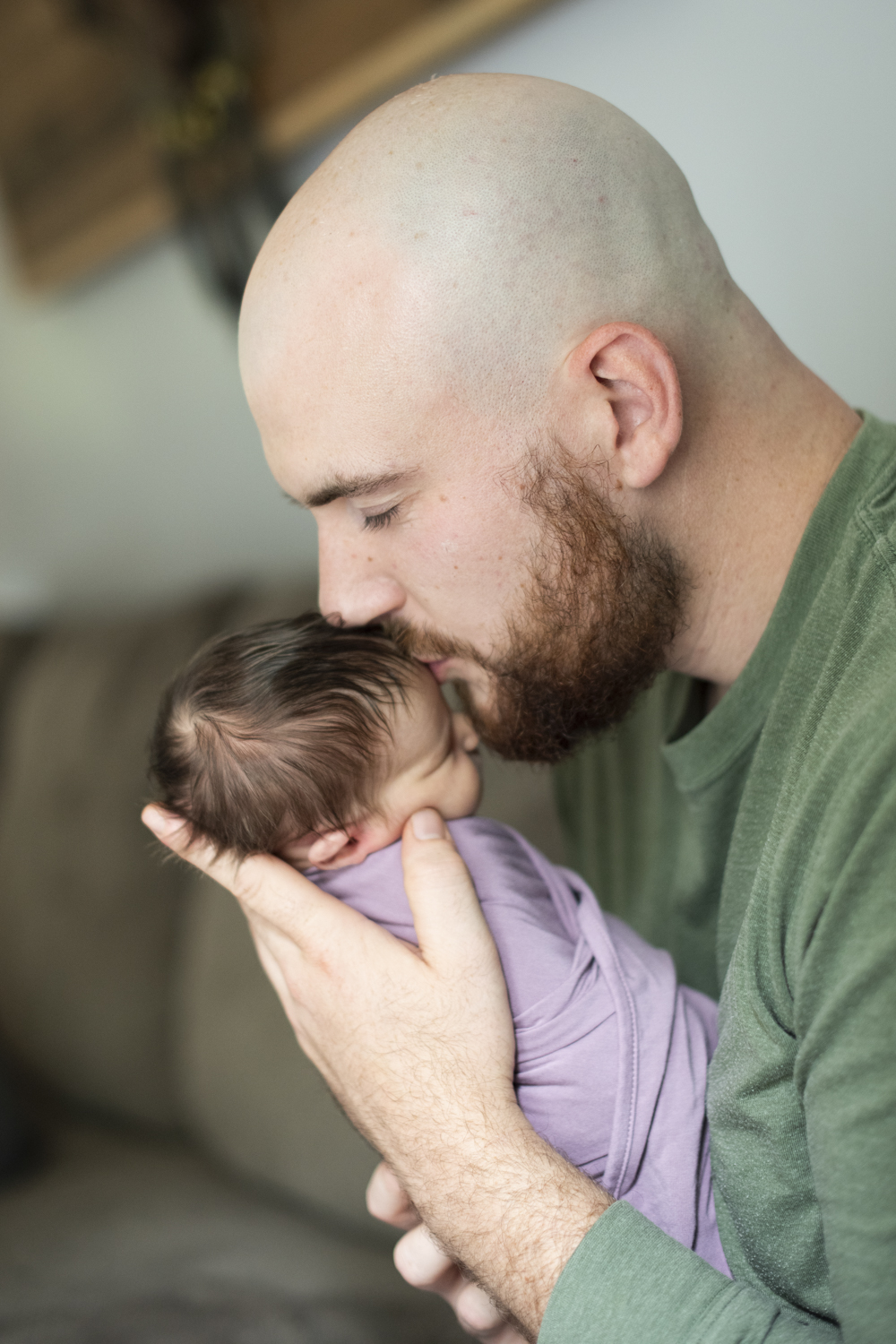 Dad kissing baby on forehead during Asheville Newborn Photography