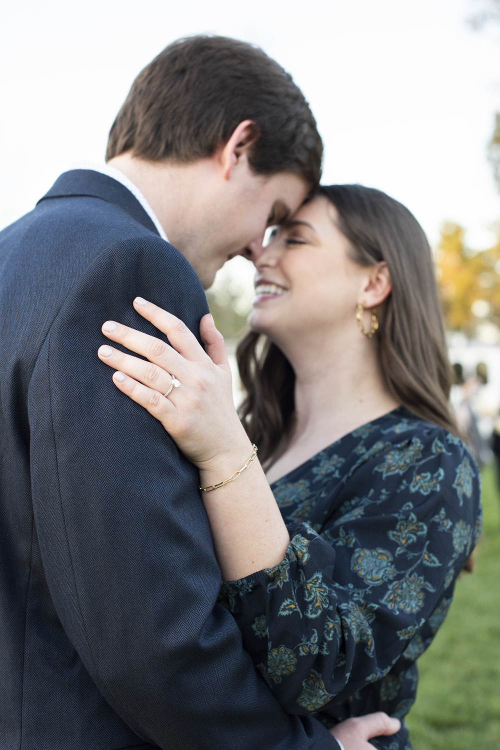 Couple showing ring at Biltmore Estate fall engagement photography