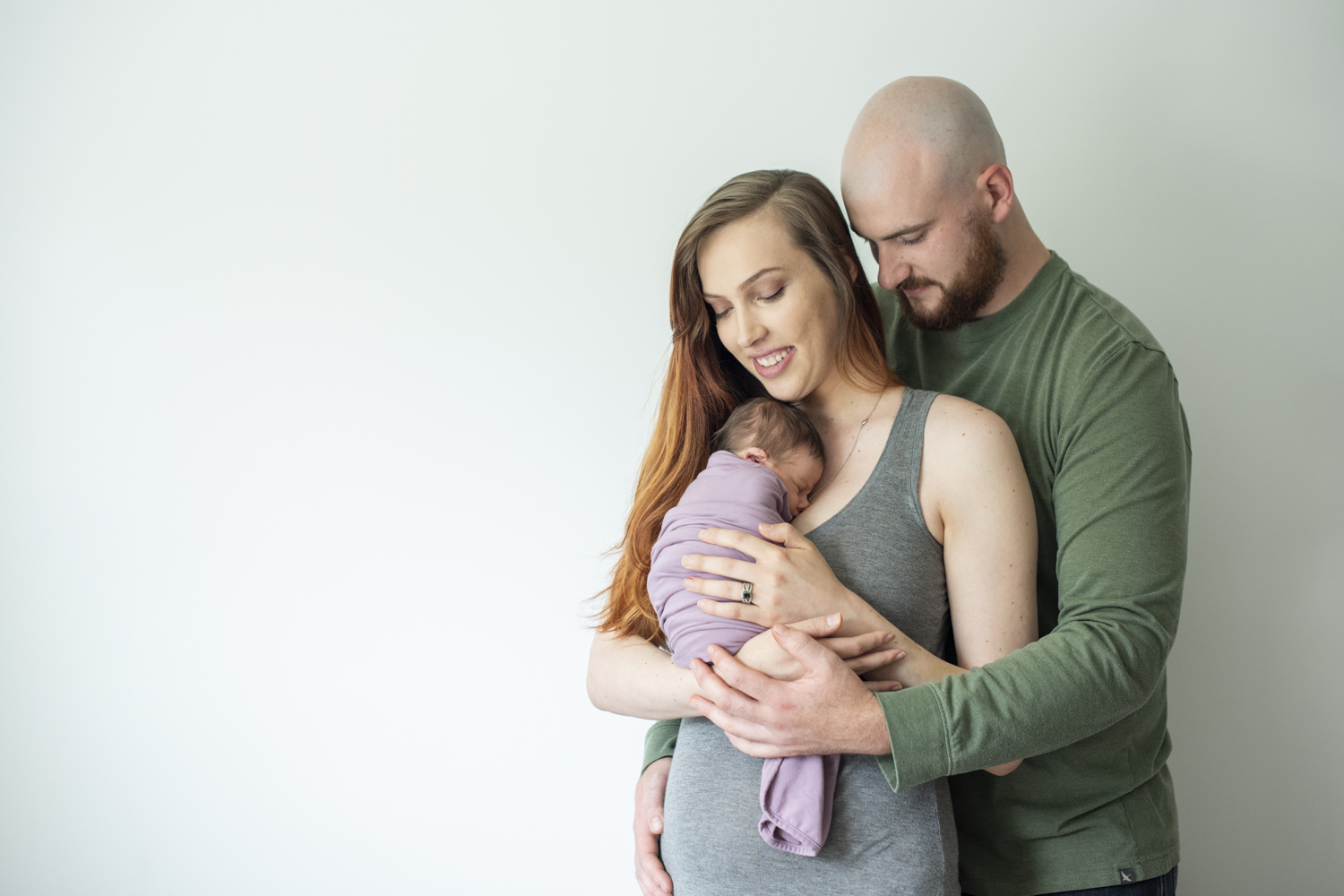 Parents holding newborn baby girl during Asheville Newborn Photography