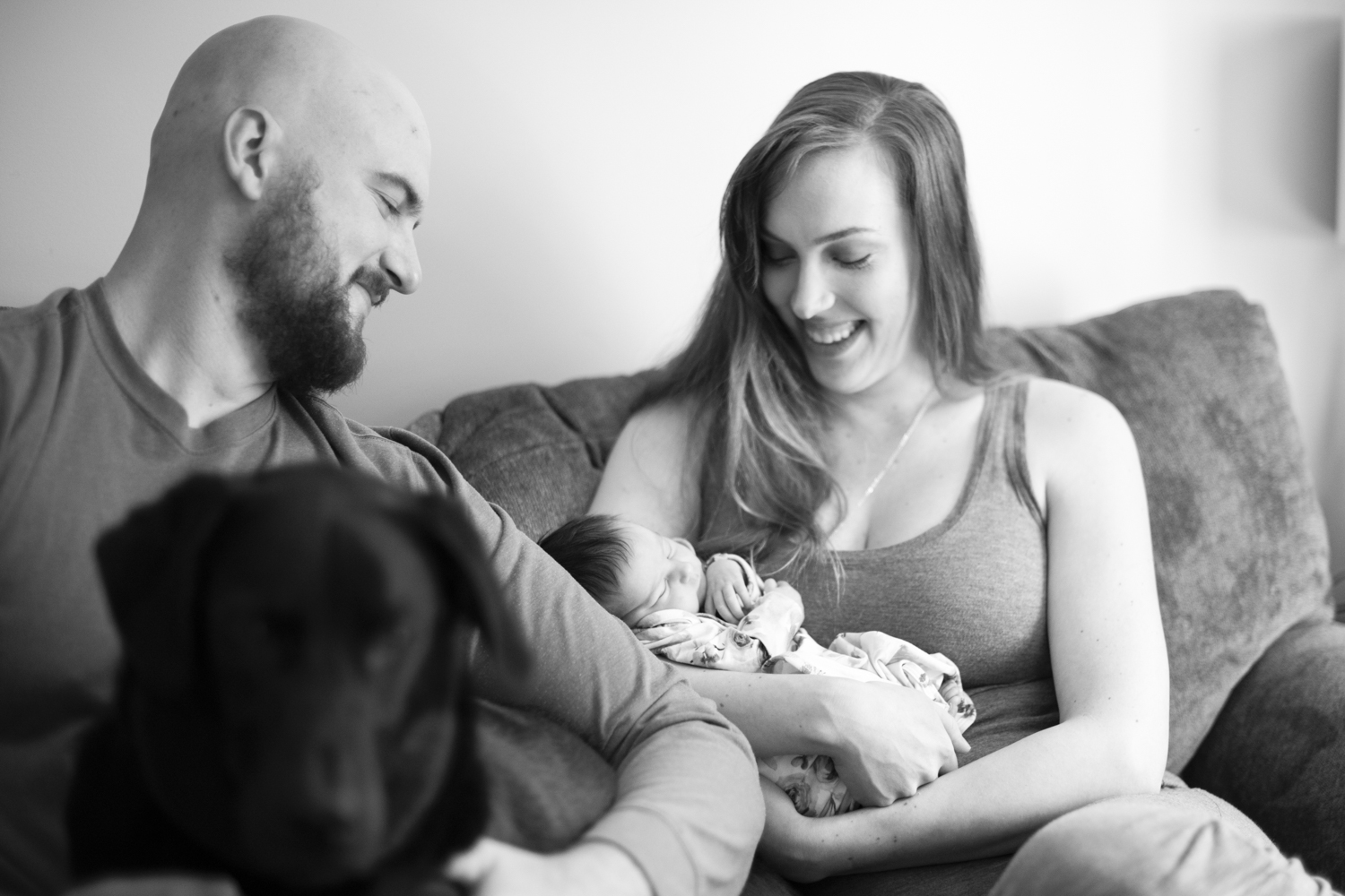 Parents smiling at newborn baby girl during Asheville Newborn Photography