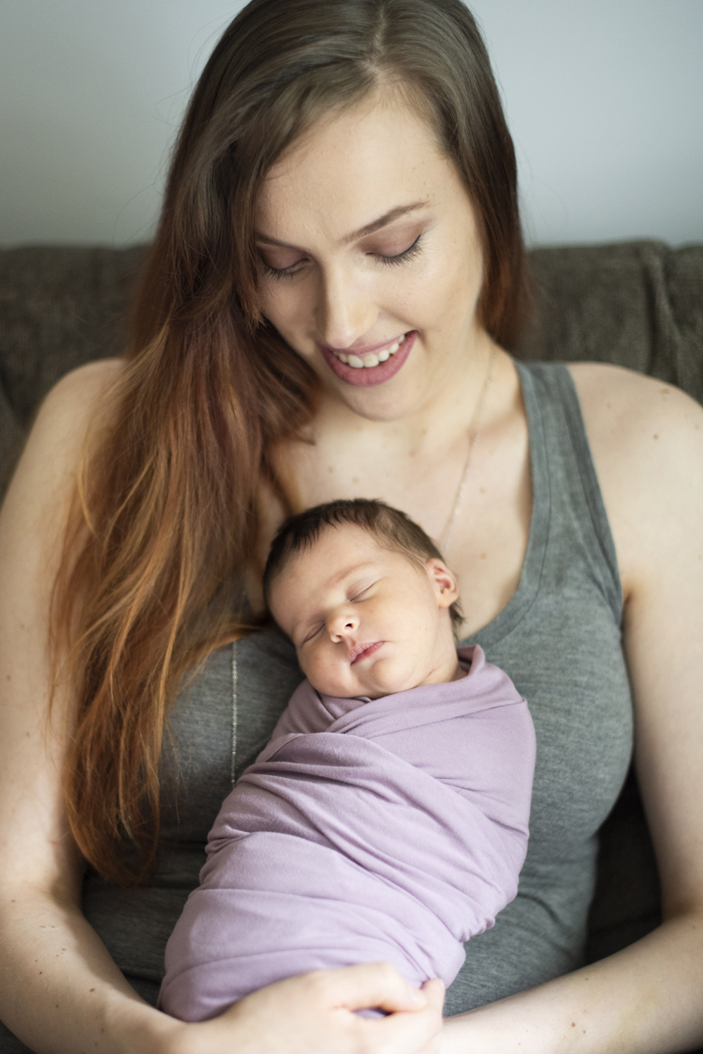 Mom holding baby on chest during Asheville Newborn Photography