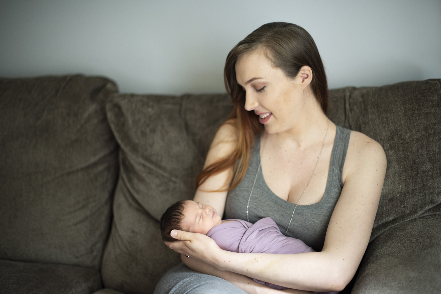 Mom snuggling newborn baby